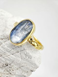 "Dainty Kyanite Cabochon Ring in 925 Sterling Silver / 18K Gold Plated * Material: High Quality Solid 925 Sterling Silver / 18K Gold Plated * Featuring Genuine Kyanite Gemstone  * Finish: Sterling Silver / Gold * All our pieces are made by hand with love + care in our workshop ♡ 💎Fun- fact time: Kyanite draws its identity from the Greek term \"cyanos\" (or \"blue\")--which this beautiful gemstone certainly is! Kyanite is one of the most attractive blue minerals in nature, sometimes exhibiting i 14k Gold Rings With Large Stone For Gift, 14k Gold Ring With Large Stone For Gift, 14k Gold Ring With Large Stone For Anniversary, Oval Yellow Gold Rings With Natural Stones, Gold Sterling Silver Rings With Natural Stones, 14k Gold Rings With Large Stone, Oval 14k Gold Rings With Natural Stones, Fine Jewelry 14k Gold Ring With Large Stone, Gold Sterling Silver Rings With Large Stone