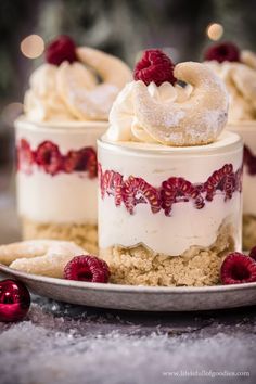 three desserts with raspberries and powdered sugar on top