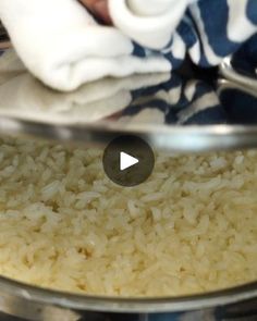 a bowl filled with rice sitting on top of a table