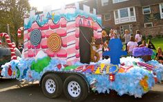 a parade float in the shape of a house with candy land on it's trailer