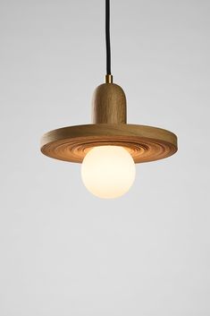 a wooden light fixture hanging from a ceiling