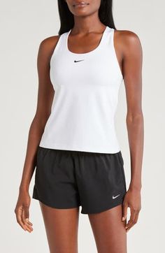 A built-in shelf-bra keeps you supported in this racerback tank top cut with signature Dri-FIT technology for cool, dry comfort as you work up a sweat. 20 1/2" length (size medium) Scoop neck Racerback Built-in shelf-bra Dri-FIT moisture-wicking technology 82% polyester, 18% spandex Machine wash, line dry Imported Nike Racerback Sports Bra For Running, Nike Stretch Tops For Light Sports, White Racerback Functional Top, Nike Racerback Activewear For Light Sports, Nike Tops For Light Sports, White Racerback Top With Mesh Back, White Mesh Back Racerback Top, Nike Racerback Activewear With Go-dry, Nike Racerback Tops For Sports Events