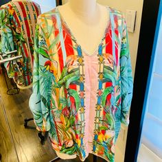 Such A Gorgeous Print Of Flowers And Birds On This Easy To Wear Blouse. The V Neck And Convertible Sleeves Makes It Super Stylish. Designed With A Vibrant Multicolor Tropical Print, It Gives You Effortless Versatility. That Lush, Tropical Details Make This Blouse Truly Something Special. Made Of Ultra-Soft Silk, It Will Quickly Become Your Favorite Piece To Layer This Season. From Parties To Walks Around The City, You Can Pair This With Your Favorite Skirt Or Jeans For A Laid-Back Boho Look. Chic Vacation Tops With Blouson Sleeves, V-neck Beachwear Blouse For Spring, Chic Tops With Blouson Sleeves For Vacation, V-neck Top With Blouson Sleeves For Beach, Summer Long Sleeve Tops With Tropical Print, Summer Multicolor Blouson Sleeve Tops, Spring V-neck Blouse For Beachwear, Multicolor Blouson Sleeves Top For Summer, Multicolor Blouson Sleeve Blouse For Brunch