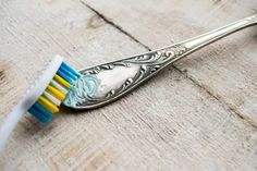 a close up of a toothbrush with blue and yellow bristles on top of it