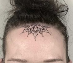 a woman with a tattoo on her head