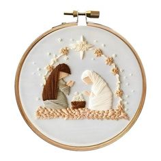 the embroidery pattern shows two people in a nativity scene