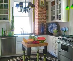 a kitchen area with a table, stove and sink in it's center island