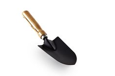 a black and gold shovel on a white background with clippings to the side