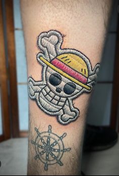 a man's leg with a skull and hat tattoo design on the side of his leg