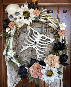 a skeleton wreath with flowers on it