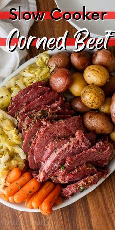 slow cooker corned beef with potatoes and carrots on a white platter