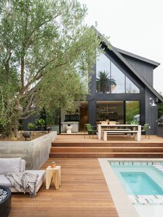 an outdoor living area with a pool and wooden decking