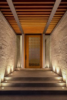 the entrance to a building with steps lit up and lights on each step are illuminated by recessed lighting