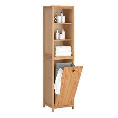 a wooden shelf with towels and other items in it