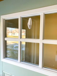 a white hat is hanging on the side of a window in front of a house