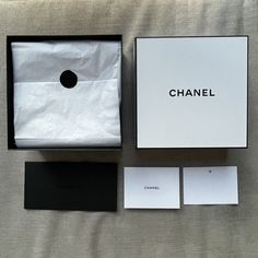 the box is open and it's next to some cards that say chanel