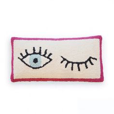 an eye rug is shown on a white surface with pink trimmings and black eyes