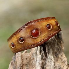 Carnelians Are Displayed Along A Leather Cuff That Has A Stainless Steel Wire Inside So It Can Be Adjusted To Allow For A Wide Range Of Wrist Sizes. Carnelian Is Known As A Stone Of Motivation And Endurance, Leadership And Courage. Carnelian Is An Orange-Colored Variety Of Chalcedony, A Mineral Of The Quartz Family. 0.65 Oz 7" L (End To End) X 1.2" W Leather, Carnelian Natural Carnelian Stone Leather Bracelet With Stone, Leather Craft Patterns, Handmade Leather Bracelets, Leather Wristbands, Polymer Clay Necklace, Clay Necklace, Leather Cuffs Bracelet, Leather Gifts, Bracelet Collection