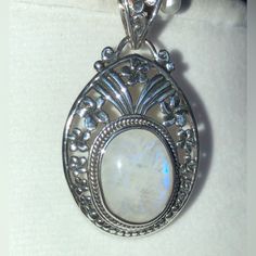 Artisan Crafted Sri Lankan Rainbow Moonstone Gemstone (9.00 Cts) In Sterling Silver Pendant Moonstone Round Pendant For Healing, Mystical Moonstone Round Pendant Jewelry, Nickel-free Moonstone Necklace With Round Pendant, Iridescent Moonstone Pendant Jewelry, Rainbow Moonstone Pendant, Artisan Craft, Sterling Silver Pendant, Rainbow Moonstone, Blue And Silver