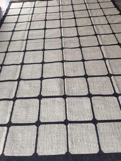 a black and white rug with squares on it