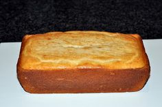 a loaf of bread sitting on top of a white counter next to a black table