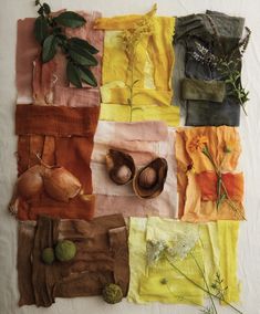 an arrangement of different colored fabrics with flowers and herbs in them on a white surface