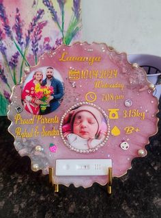 a pink plaque with pictures and words on it sitting on top of a granite counter