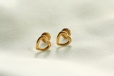 Open heart-shaped earrings, handmade with 18k yellow gold. Simplicity at its best, these classic studs are light enough to wear comfortably, but solid -- made with real, 18k gold -- a quality generally reserved for more expensive pieces. If you have a question, please send a message ... I'm always happy to help! These earrings were handcrafted with love in Los Angeles, California. Simple Gold Studs, Earrings Heart, Heart Stud Earrings, Heart Shaped Earrings, Heart Studs, Open Heart, Heart Earrings Studs, Gold Studs, Earrings Handmade