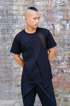 Unique cut and sew t-shirt with decorative panel at front to form asymmetrical shape.  Fabric: 92/8 cotton/elastine blend Male Model: 179cm weight 75kg Female Model: 163cm weight 63kg Both wearing Size M Black Asymmetrical Cotton Top, Modern Asymmetrical Cotton Tops, Cotton T-shirt With Asymmetrical Hem For Summer, Summer Cotton T-shirt With Asymmetrical Hem, Female Model, Mad Men, Male Model, Really Cool Stuff, Gender Neutral