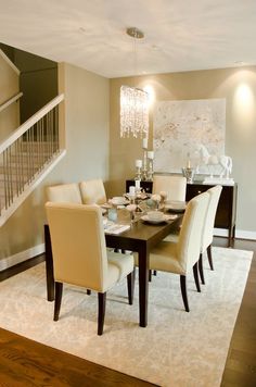 a dinning room table with chairs and a chandelier