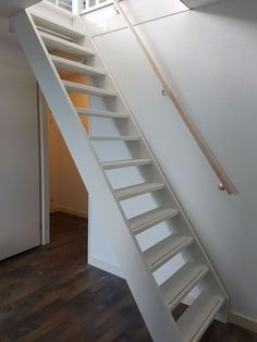 a white stair case in an empty room