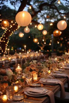 an outdoor dinner table set up with candles and flowers in vases on the tables