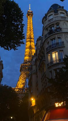 the eiffel tower is lit up at night