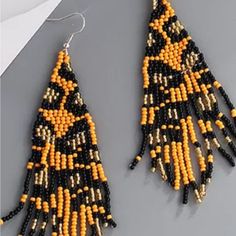 Nwt Womens Cheetah Beaded Long Dangle Earrings. Orange Beaded Earrings With Black Beads, Orange Beaded Dangling Earrings For Summer, Summer Orange Beaded Dangling Earrings, Orange Dangle Beaded Earrings With Black Beads, Orange And Black Beads Dangle Earrings, Orange Dangle Earrings With Black Beads, Orange Beaded Fringe Jewelry, Orange Beaded Dangling Earrings For Beach, Orange Dangle Jewelry With Black Beads