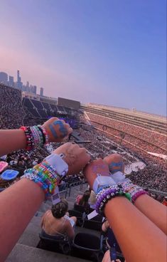 several people wearing bracelets and wrist bands at a sporting event