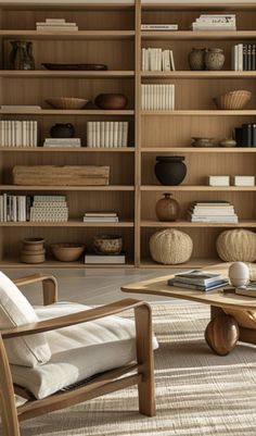 a living room filled with lots of wooden furniture and bookshelves full of books