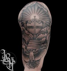 the back of a man's arm with an open gate and clouds on it