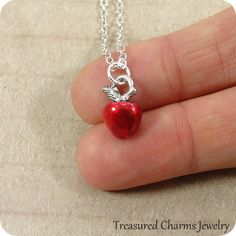 "This Red Apple Charm necklace comes on a silver-plated chain that is available in different lengths. Please choose your desired length from the drop-down menu when placing the item in your shopping cart. { CHARM DETAILS } ★ Material: Pewter and Red Enamel ★ Finish Color: Silver ★ Measurements: 1/4\" x 1/2\" ★ Dimensions: Double-sided ★ Made in the USA { SIMILAR ITEMS } More apple themed items available from my shop: https://www.etsy.com/shop/treasuredcharms/search?search_query=apple { GIFT OPTI Red Nickel-free Charm Necklace For Gift, Red Pendant Charm Necklace In Metal, Red Metal Pendant Charm Necklaces, Red Metal Pendant Charm Necklace, Red Nickel-free Pendant Charm Necklace, Nickel Free Red Metal Charm Necklaces, Nickel-free Red Metal Charm Necklaces, Apple Gifts, Red Apple