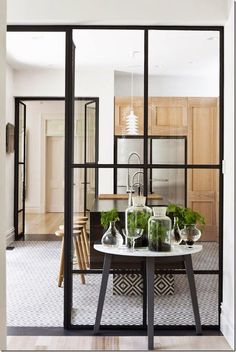 an open kitchen and dining room with glass doors