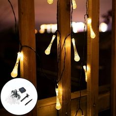 some lights that are hanging on the side of a wooden structure with an image of a city in the background