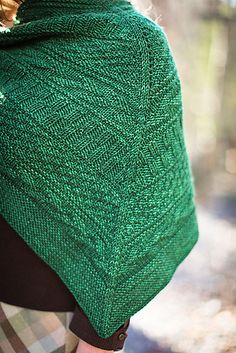 a woman wearing a green shawl in the woods