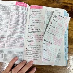 a person holding an open book with writing on it