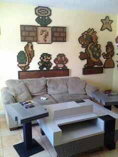 a living room with couches, tables and pictures on the wall above them that are made out of cardboard boxes