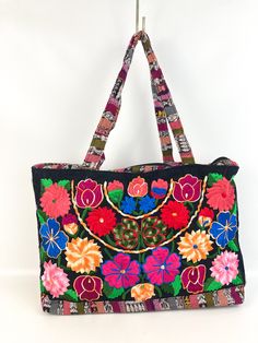 "For sale is this Mexican Hand Embroidered Zippered Closure Cloth Tote Bag Chiapas Rainbow Flowers. This large bag measures approx. 17\" across X 12\" high. Inside is a large zippered pocket. This is a large roomy tote bag/purse that can be used for many things.   The top handles have a 9\" drop from the top of the handle to the top edge of the tote. From a smoke/pet free home. Excellent condition. Clean inside and out and appears to have never been used. *Please keep in mind that the shipping p Embroidered Multicolor Hobo Bag For Travel, Multicolor Embroidered Hobo Bag For Travel, Embroidered Multicolor Hobo Bag, Multicolor Floral Embroidered Tote Shoulder Bag, Rectangular Multicolor Embroidered Hobo Bag, Multicolor Floral Embroidery Tote Shoulder Bag, Embroidered Multicolor Hobo Tote Bag, Multicolor Floral Embroidered Tote Bag, Multicolor Floral Embroidered Shoulder Bag For Travel