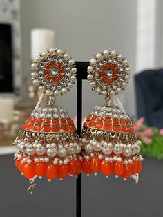 Lightweight jhumka earrings.  available in 2 colors- pearl, blue Earrings length- 4 inches Bollywood Beaded Earrings With Latkans For Celebration, Bollywood Style Beaded Earrings With Latkans For Celebration, Traditional Orange Earrings For Party, Bollywood Chandbali Earrings With Latkans, Festive Bollywood Chandbali Beaded Earrings, Bollywood Festive Jhumkas Dangle Earrings, Bollywood Style Festive Dangle Jhumkas, Bollywood Style Beaded Earrings For Festivals, Bollywood Chandbali Beaded Earrings For Diwali