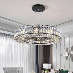 a living room filled with furniture and a large chandelier hanging from the ceiling