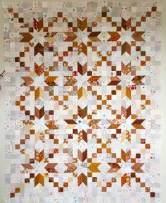 an old quilt is hanging on the wall