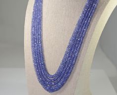 Tanzanite five strand necklace of faceted graduated rondelles with an adjustable silk cord.  Well matched , beautifully faceted, natural tanzanite fine quality beads. Tanzanite is a birthstone for December and the 24th wedding anniversary gemstone. Natural tanzanite from Tanzania 469 carats graduating from 3 to 7.5 mm The closure is an adjustable silk cord with tassels The length of the shortest strand is 18 inches and the longest is 21 inches Jewelry from Stowe Gems arrives beautifully packaged Tanzanite Beads Jewelry Indian, 24th Wedding Anniversary, Stowe Vt, Australian Opal Ring, Garnet And Diamond Ring, Tanzanite Necklace, Tanzanite Jewelry, Gold Necklace Simple, White Gold Earrings Studs