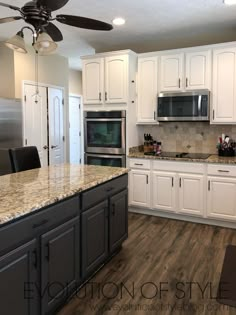 a kitchen with white cabinets and granite counter tops