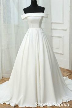 a white wedding dress on a mannequin